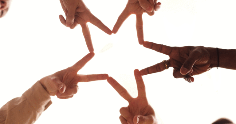 Five hands forming a star with their fingers, representing alignment in business strategy and the power of flow over force.