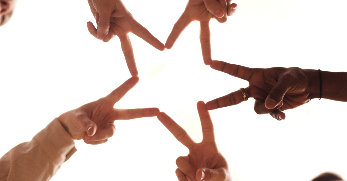 Five hands forming a star with their fingers, representing alignment in business strategy and the power of flow over force.