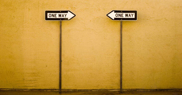 Two arrows pointing toward each other with “One Way” signs, symbolizing the Law of Polarity and the connection between failure and success.