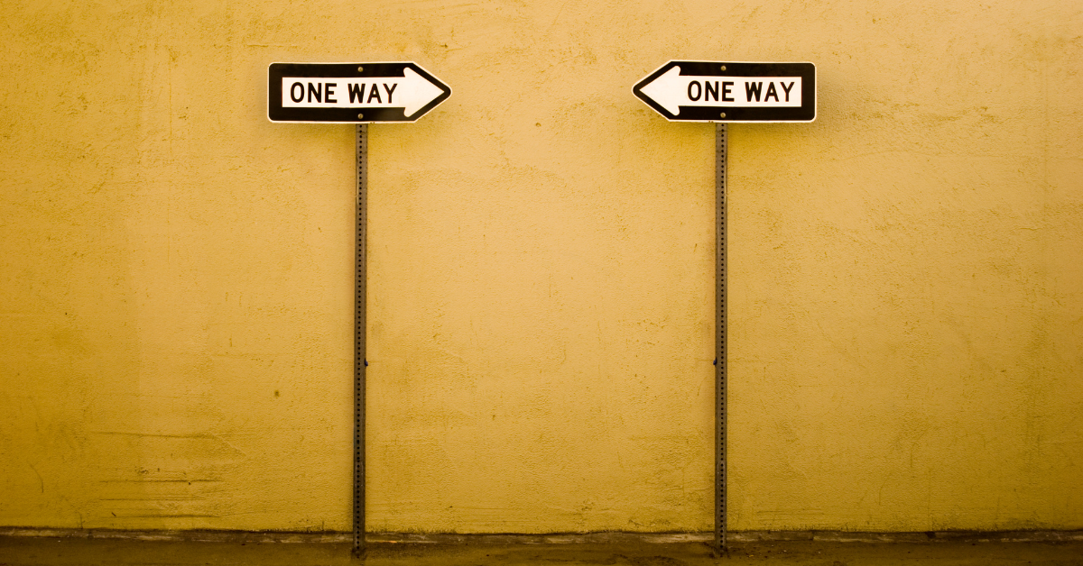 Two arrows pointing toward each other with “One Way” signs, symbolizing the Law of Polarity and the connection between failure and success.